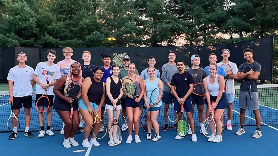 Club tennis team poses on the court