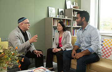 Bryant Rabbi Steven Jablow talks with two students