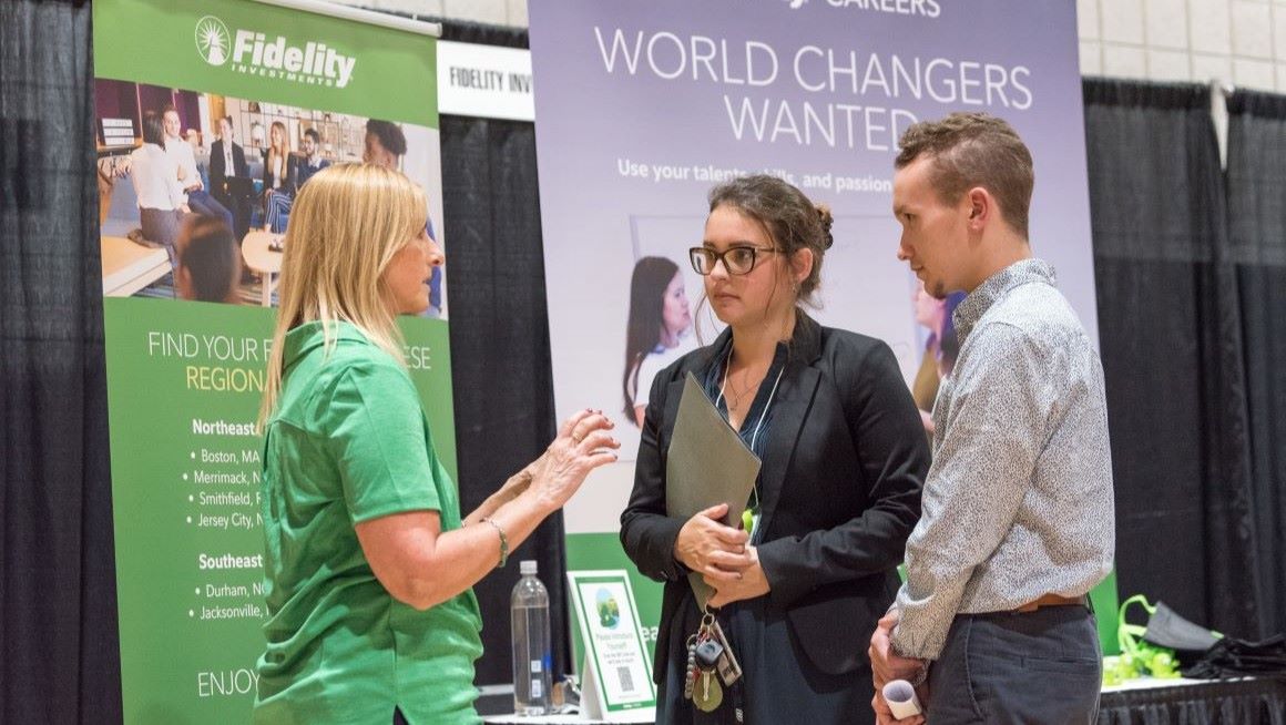Students talk with a recruiter at Bryant's Career Fair. 