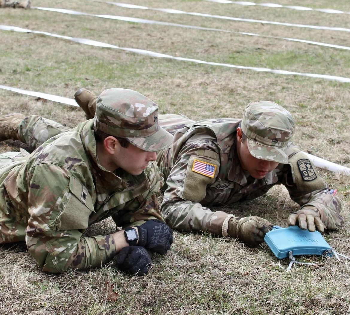 Cadets work on placing claymore mines during joint field training exercises.