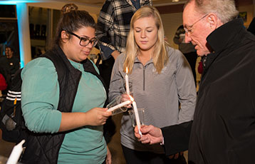 Bryant students and light President Ronald K. Machtley's candle during the University's annual Festival of Lights celebration.