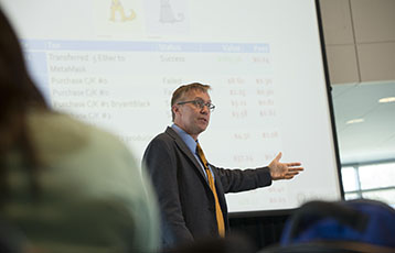 Bryant Professor Kevin Mentzer teaches in class