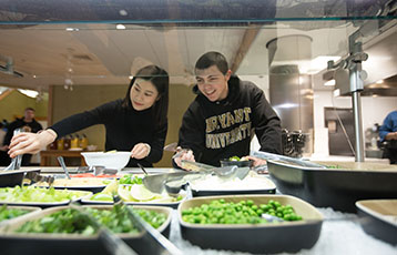 Bryant students select food at Salmonson Dining Hall