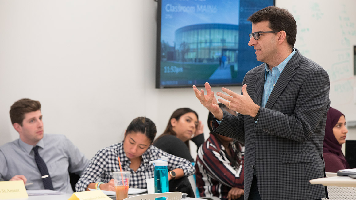 Bryant University Professor Michael Roberto teaches during an MBA class.