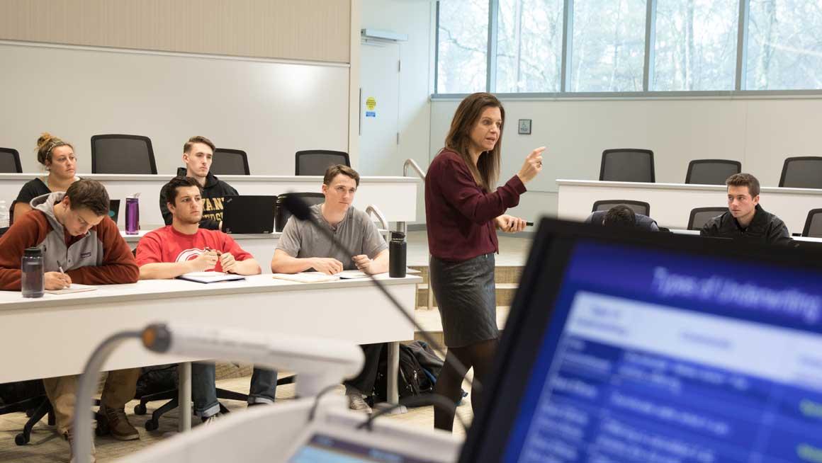Bryant University Professor Maura Derderian in a classroom full of students at the Quinlan / Brown Academic Innovation Center.