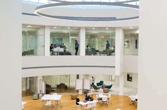 Students work inside the forum and on the second floor of the Quinlan / Brown Academic Innovation Center at Bryant University.