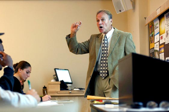 Bryant University Professor Gregg Lee Carter speaks to a roomful of students.