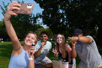 A group of Bryant University students gather for a selfie during the school's organization fair.