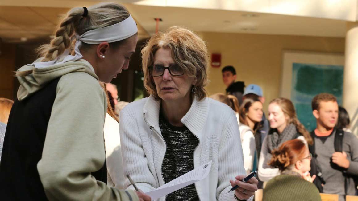 Bryant University Professor Judith McDonnell speaks to a student.