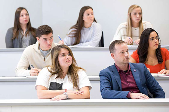 Students in a tiered classroom at Bryant University.
