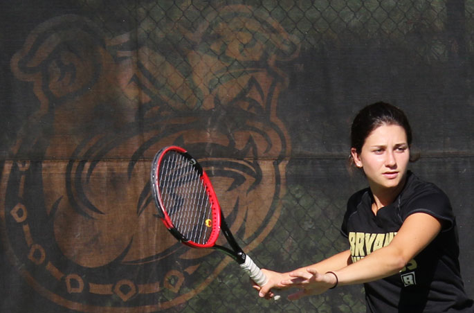 A Bryant women's tennis player prepares to return the ball.