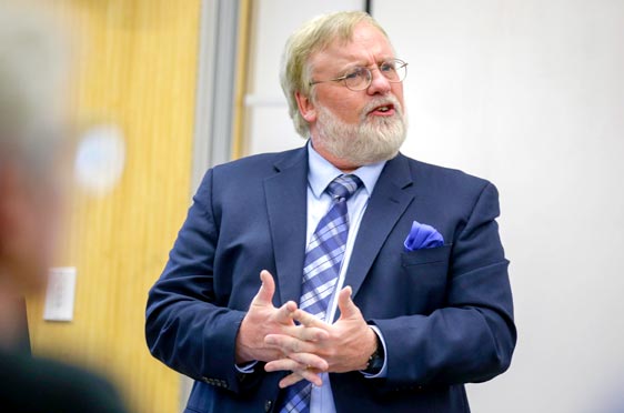 Bryant professor Rick Gorvett lectures in a classroom