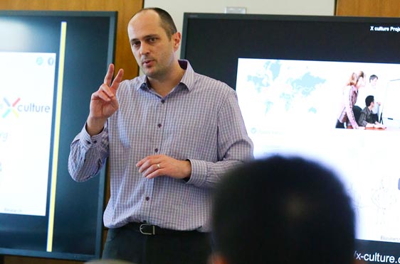 Bryant Professor Srdan Zdravkovic lectures to a room of students.