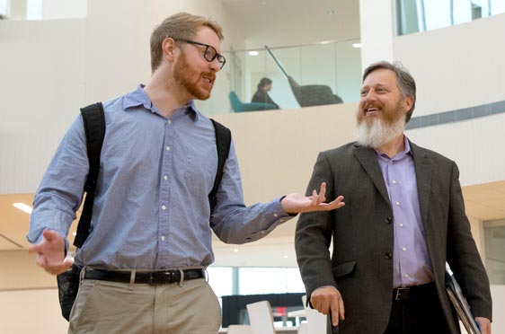 Bryant Professor Michael Gravier speaks with a student.