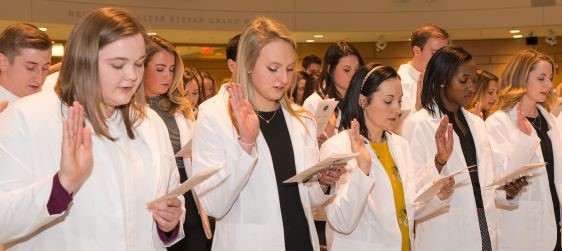 Students recite oath during White Coat Ceremony.