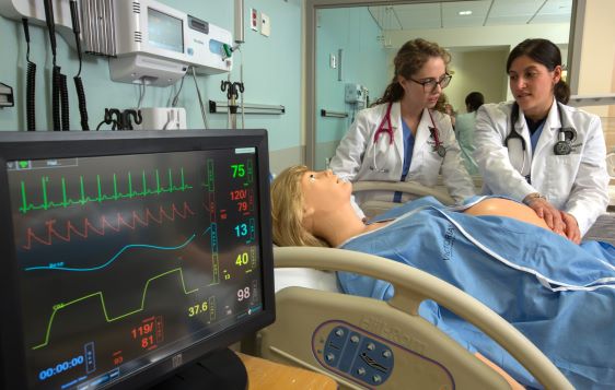 Students practice on a manikin in the high-fidelity medical simulation center.