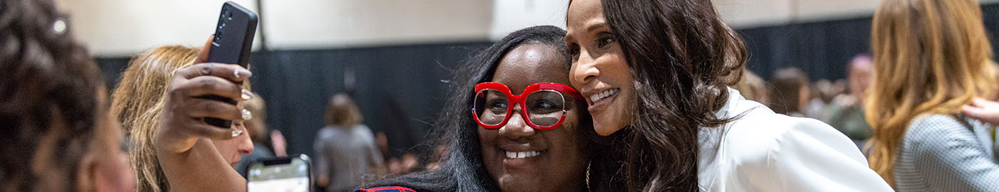 A student poses with Beverly Johnson at the 2023 Women's Summit at Bryant University.