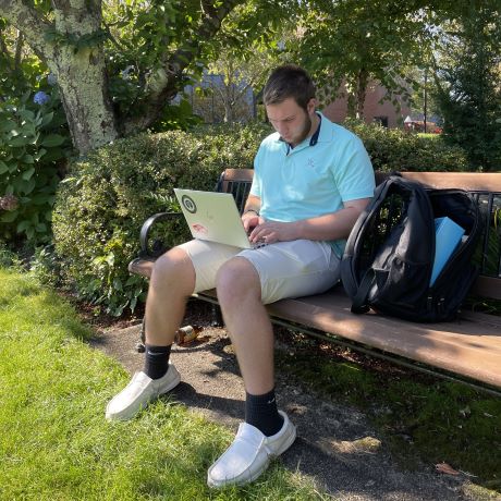 Jack Wagstaff '26 works at a bench by the pond.