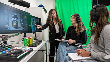 Bryant University Marketing Professor Sharmin Attaran talks to students in the digital marketing lab.