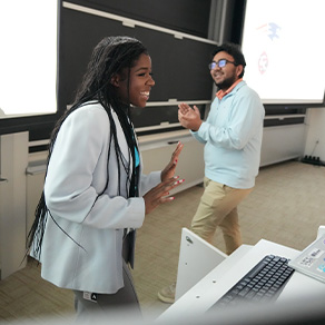 A Bryant University student smiles as she delivers a presentation.