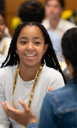 A Bryant University student listens to a conversation.