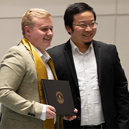 Bryant University Professor Gao Niu poses with Luke Lamontagne.