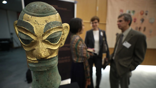 An ornamental mask is displayed at Bryant University.