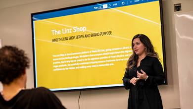 Bryant University Professor Sharmin Attaran lectures in front of a class.