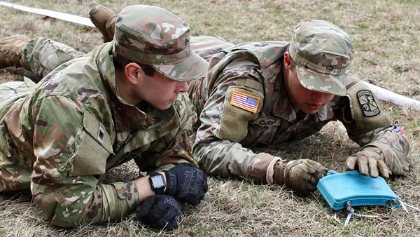Cadets work on placing claymore mines during joint field training exercises.