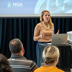 A woman delivers a presentation at a conference for the Northeast Gas Association held at Bryant University.